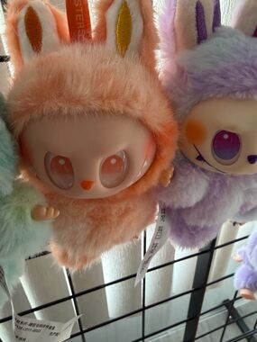 Orange labubu doll